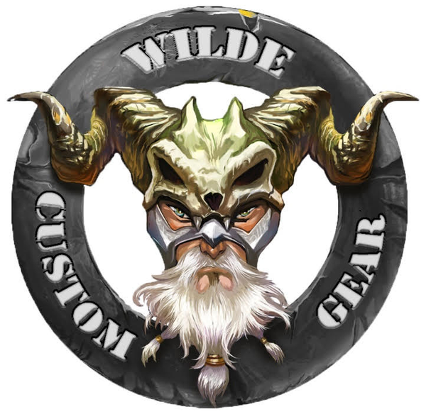 A circular logo featuring a mythical warrior with horns, a white beard, and intense eyes, surrounded by the text 'Wilde Custom Gear,' symbolizing strength and craftsmanship.