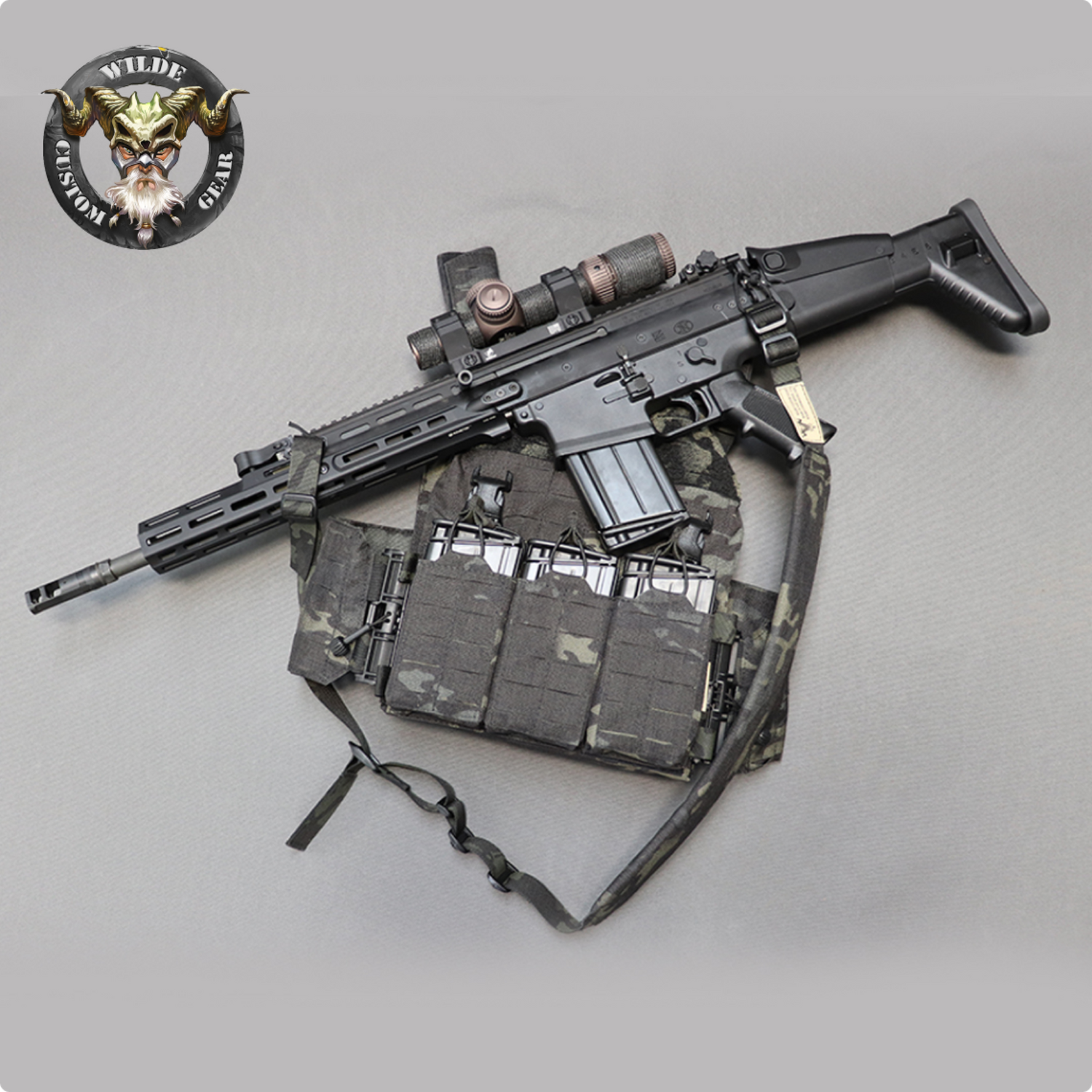 A tactical rifle equipped with a scope and mounted on a modular gear setup, featuring the Wilde Custom Gear logo, highlighting precision craftsmanship and military-grade design.